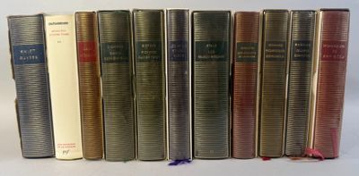 books are lined up in a row on a white surface