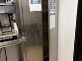 a stainless steel refrigerator in the corner of a kitchen