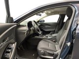 the interior of a car with the door open and the driver ' s seat down