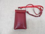 red leather phone case with a red strap on a white surface