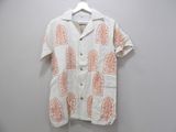 an orange and white shirt hanging on a white wall