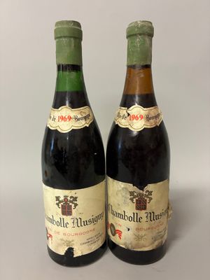 two bottles of wine sitting next to each other on a table