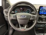 the interior of a car with a steering wheel, dashboard, and a touch screen