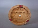 a wooden clock that has writing on it