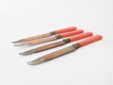 four different types of tools sitting on top of a white surface