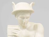 statue of a man with a flute in his hands