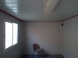 a empty room with a chair in it and a window
