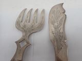 pair of antique silverware forks with floral designs on them