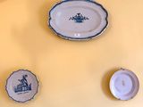 three plates that are on the wall next to each other