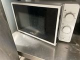a microwave sitting on top of a metal counter