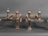 three metal candles are sitting next to each other on a table