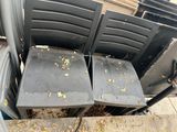 many chairs that are sitting on the side of the street