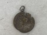 a silver coin with a picture of a man on it