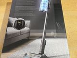 the box is open on a table with a vacuum on it