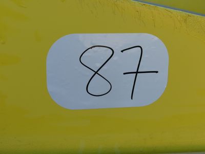 a sticker that says s & f on the side of a yellow car