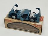 a blue toy car in a box on a white surface