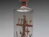 a glass bottle with a picture inside of it