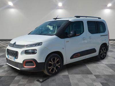 a white van parked on a checkered floor in a garage