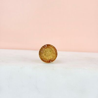 a gold coin sitting on top of a white counter
