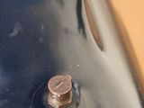 a penny sitting on top of a black vase