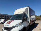the white van is parked in the parking lot next to the building