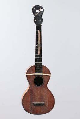 a wooden ukule with a black face on top of it
