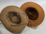two hats that are sitting next to each other on a table
