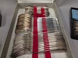 a lot of silverware in a box on a table