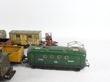 several toy trains are lined up next to each other on a white surface