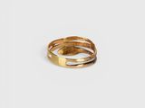 a close up of a gold ring on a white surface