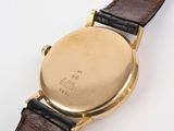 an image of a close up of a wrist watch on a white surface