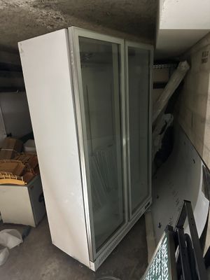 a refrigerator that is sitting in the corner of a room