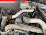 a close up of a car ' s engine and its hoses