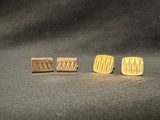 three pairs of wooden stud earrings sitting on top of a black surface