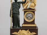 a statue of a woman holding a harp and a clock