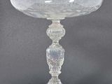 a glass bowl on a pedestal on a table