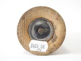 a wooden spool with a label on it