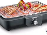 an image of a grill with meat and vegetables cooking on it