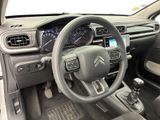 the interior of a car with a steering wheel and dashboard controls