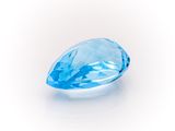 a close up of a blue topazte gems on a white background