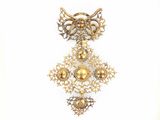 a picture of a brooch that is hanging on a wall