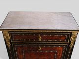 an antique chest of drawers with a marble top and gold trimming