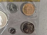 four coins in the package on the table next to each other