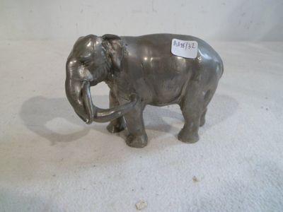 statue of an elephant with a tag on it ' s tusk