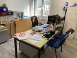 a desk with a chair and a lamp in the corner of the room