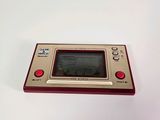 an old game console sitting on top of a white table
