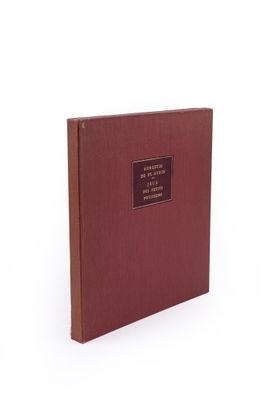 a book with a red cover sitting on top of a white surface