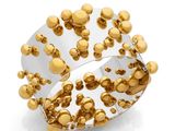 a close up of a ring with gold balls on it
