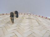 a pair of sunglasses sitting on top of a wicker basket