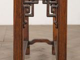 an old wooden table with a clock on top of it